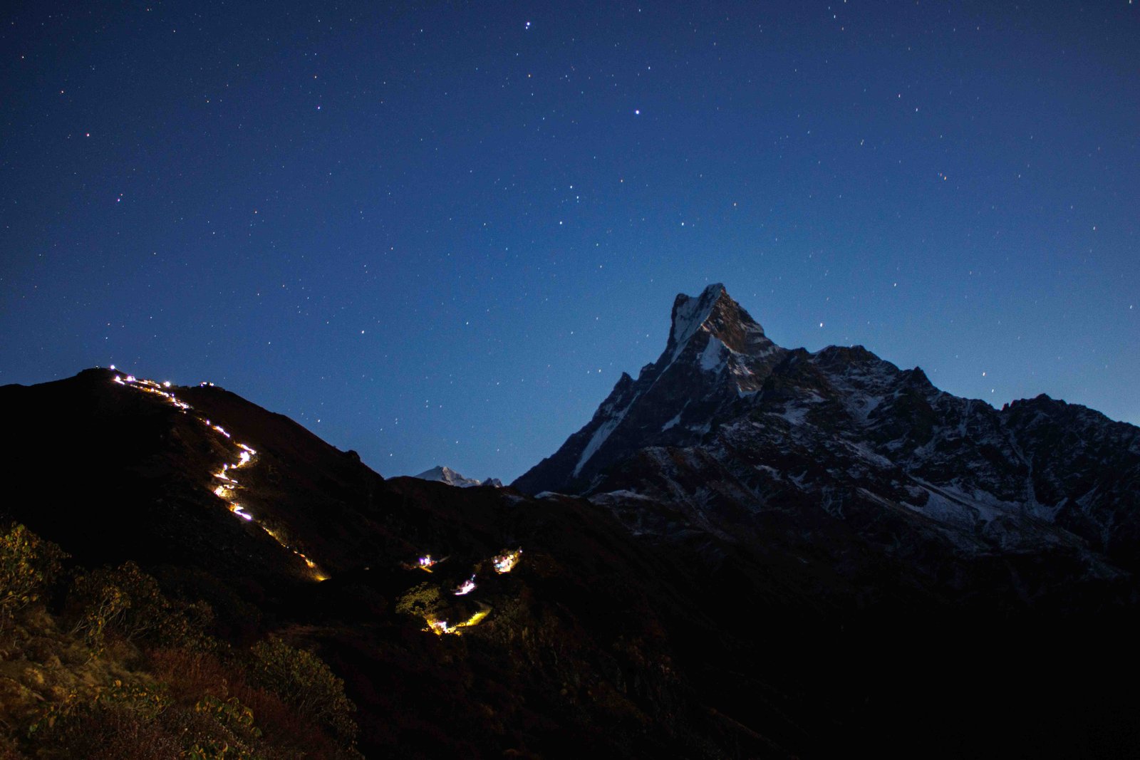 Headlamps of trekkers climbing towards the Mardi Himal viewpoint before sunrise