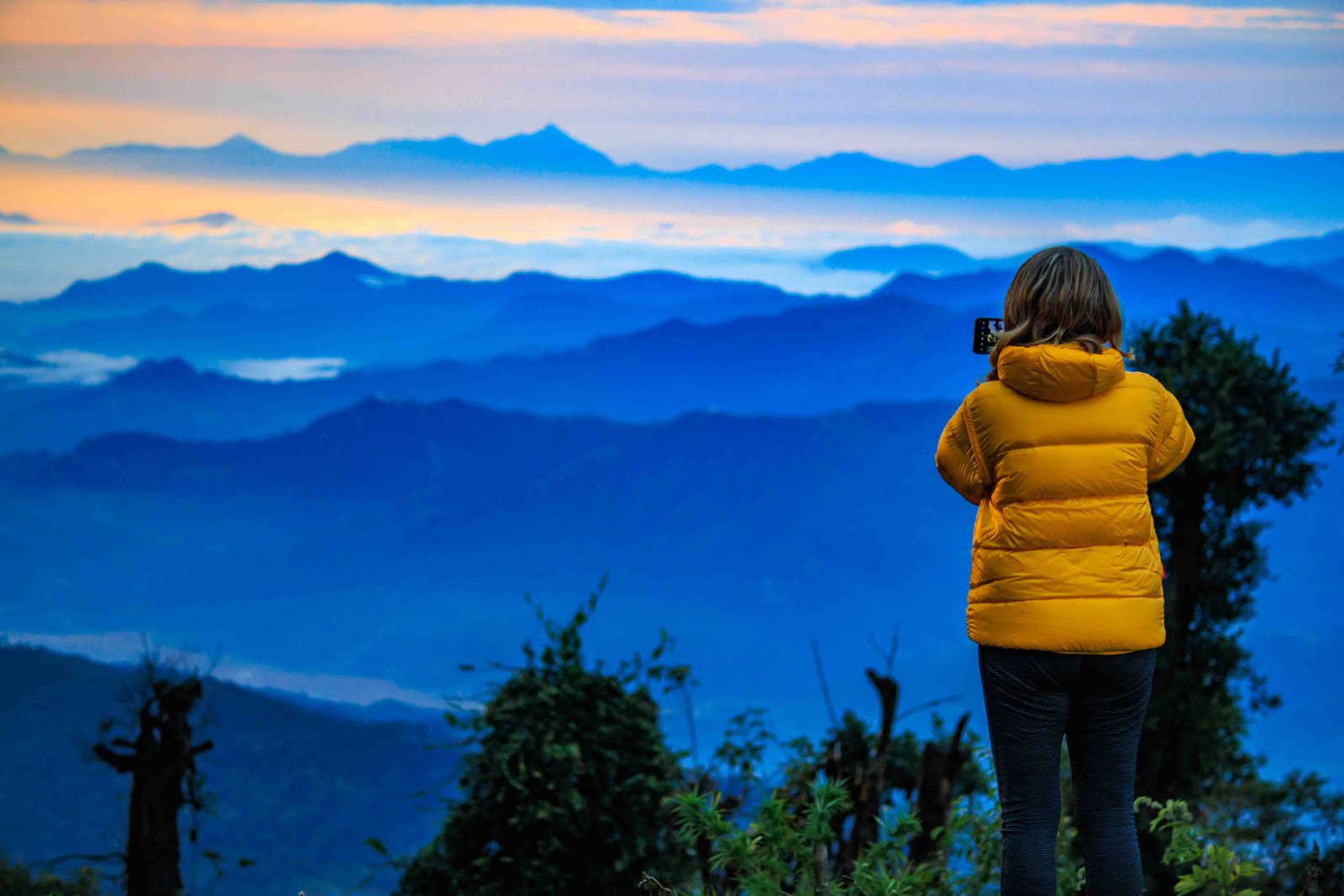 Trekker looking over a sea of clouds from Suire Danda on the Mardi Himal Trek