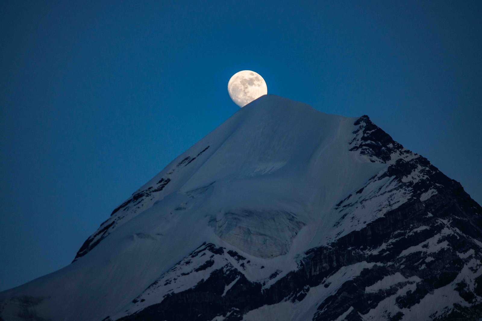 Moonrise over the mountains at Api Base Camp
