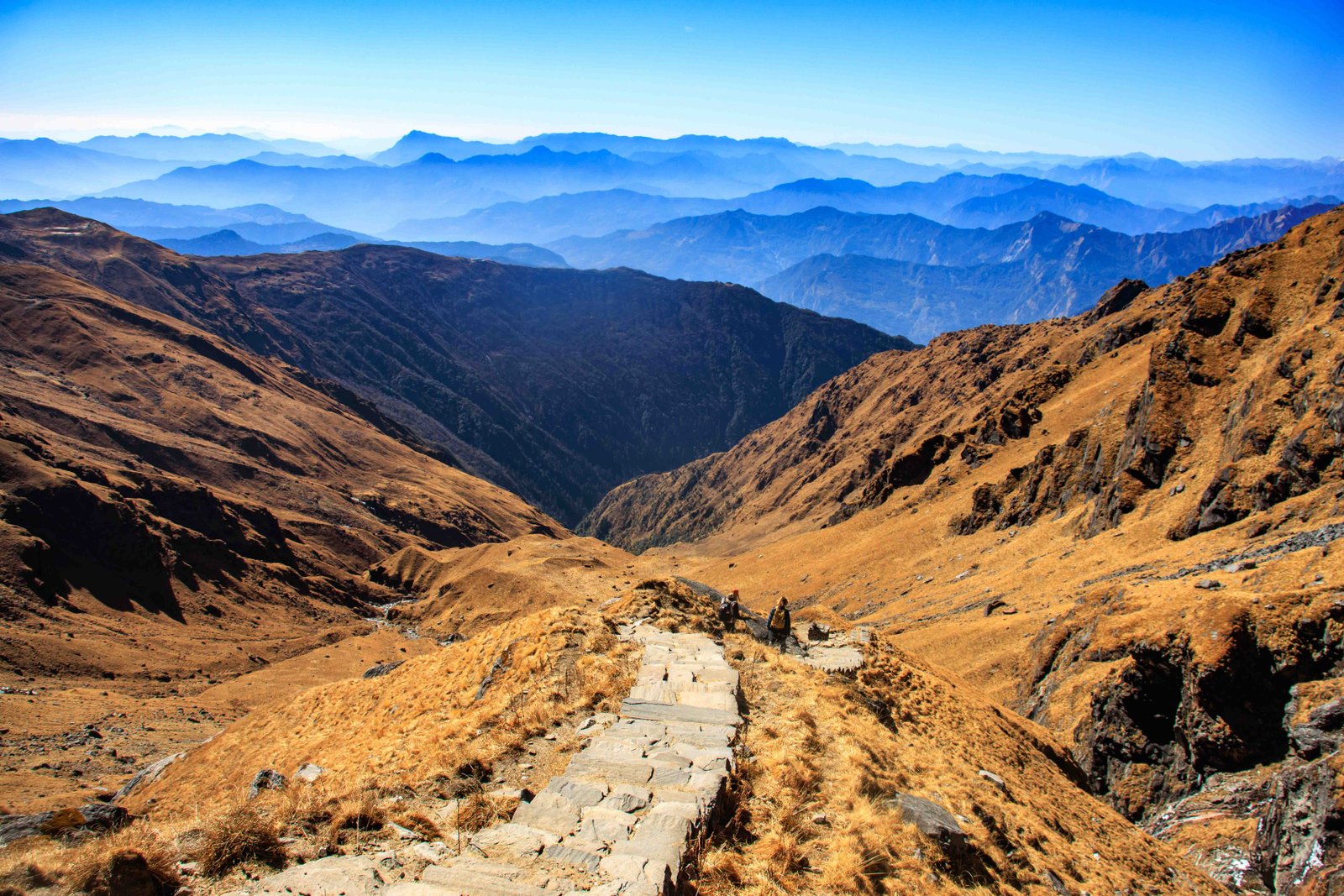 Stone steps on the final climb to Khayer Lake with layers of hills below